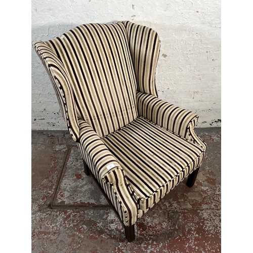 103 - A Georgian style fabric upholstered wingback armchair