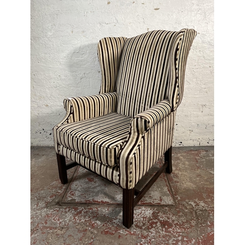 103 - A Georgian style fabric upholstered wingback armchair