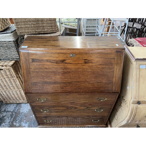 108 - A mid 20th century oak bureau - approx. 100cm high x 74cm wide x 37cm deep