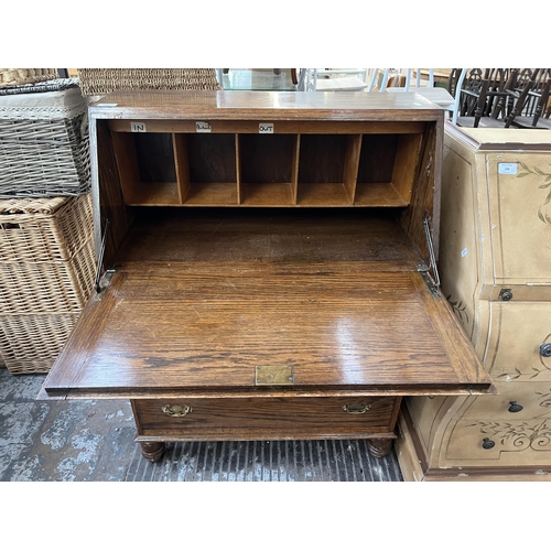 108 - A mid 20th century oak bureau - approx. 100cm high x 74cm wide x 37cm deep