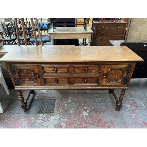 112 - An early 20th century carved oak sideboard - approx. 88cm high x 158cm wide x 48cm deep