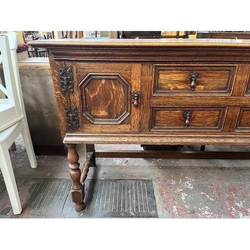 112 - An early 20th century carved oak sideboard - approx. 88cm high x 158cm wide x 48cm deep