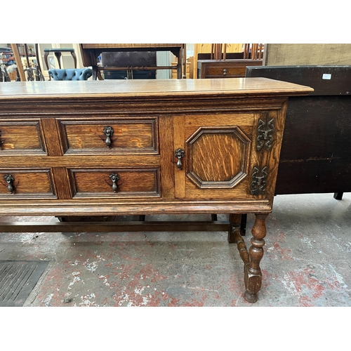 112 - An early 20th century carved oak sideboard - approx. 88cm high x 158cm wide x 48cm deep