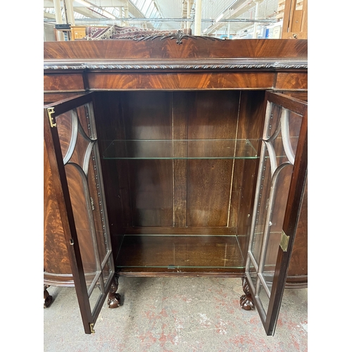 115 - An Edwardian mahogany display cabinet on ball and claw supports with two glazed doors and two outer ... 