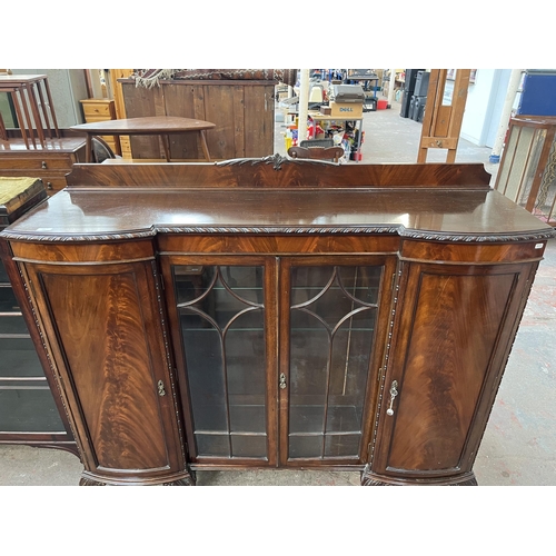 115 - An Edwardian mahogany display cabinet on ball and claw supports with two glazed doors and two outer ... 