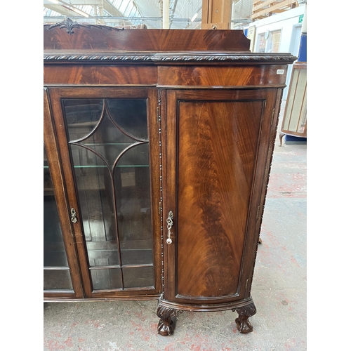 115 - An Edwardian mahogany display cabinet on ball and claw supports with two glazed doors and two outer ... 