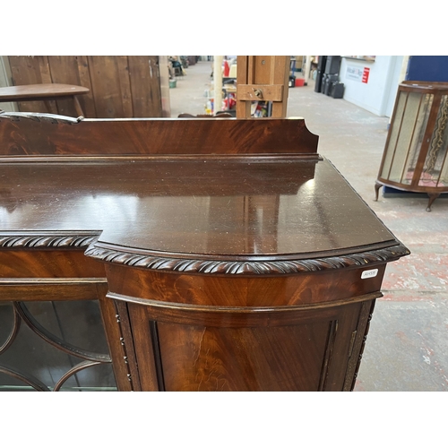 115 - An Edwardian mahogany display cabinet on ball and claw supports with two glazed doors and two outer ... 