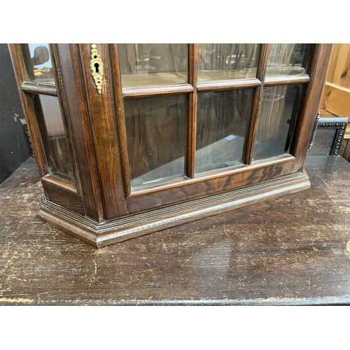 121 - An oak wall mountable display cabinet with single glazed door - approx. 70cm high x 65cm wide x 17cm... 