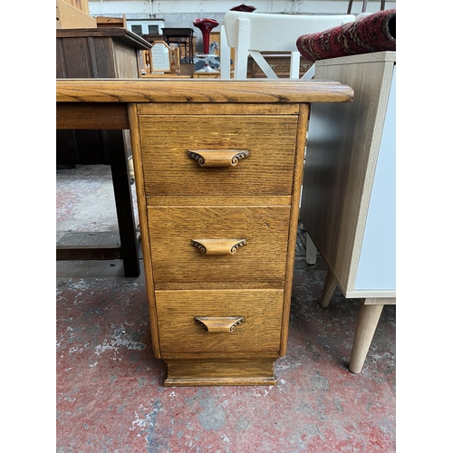 125 - A mid 20th century carved oak desk - approx. 74cm high x 137cm wide x 46cm deep