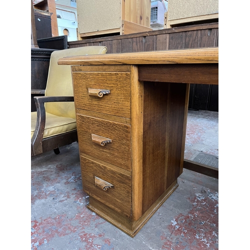 125 - A mid 20th century carved oak desk - approx. 74cm high x 137cm wide x 46cm deep