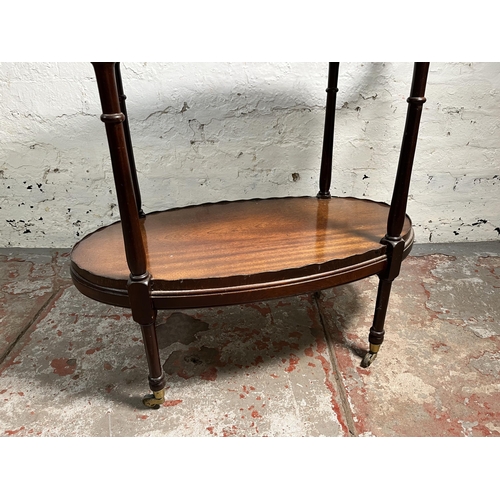 130 - A 19th century style inlaid mahogany pie crust edge oval two tier tea trolley on brass castors - app... 