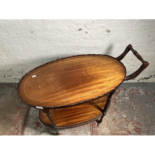 130 - A 19th century style inlaid mahogany pie crust edge oval two tier tea trolley on brass castors - app... 