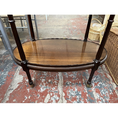 130 - A 19th century style inlaid mahogany pie crust edge oval two tier tea trolley on brass castors - app... 