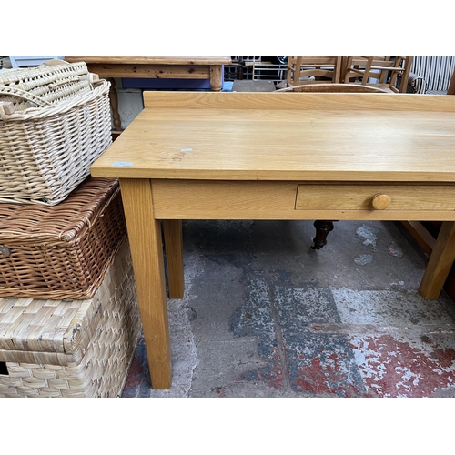 131 - A modern oak writing desk - approx. 82cm high x 122cm wide x 56cm deep