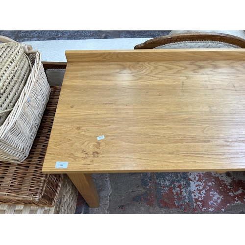 131 - A modern oak writing desk - approx. 82cm high x 122cm wide x 56cm deep