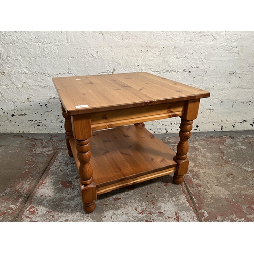 133 - A pine two tier side table - approx. 47cm high x 55cm wide x 55cm long
