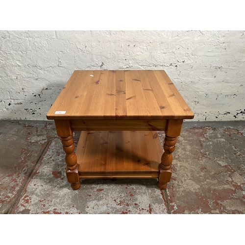 133 - A pine two tier side table - approx. 47cm high x 55cm wide x 55cm long