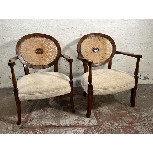 139 - A pair of walnut and rattan bergere armchairs with fabric upholstery