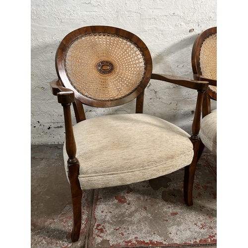 139 - A pair of walnut and rattan bergere armchairs with fabric upholstery