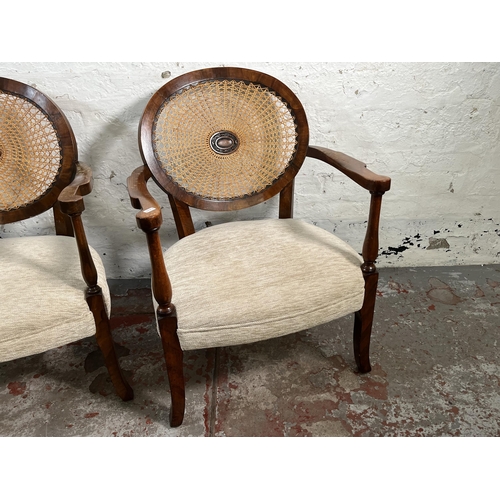 139 - A pair of walnut and rattan bergere armchairs with fabric upholstery