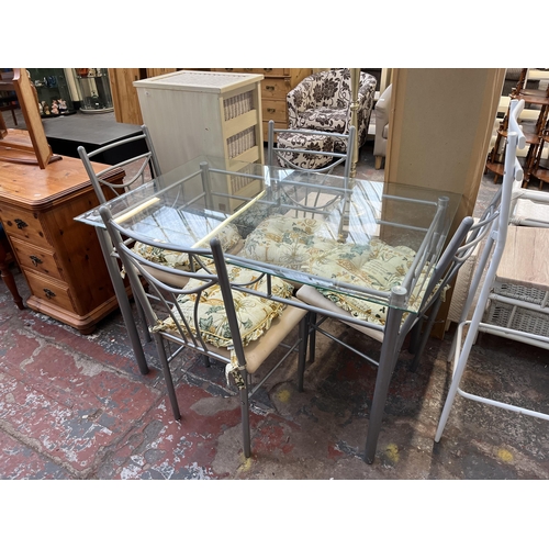 140 - A modern bevelled glass top and metal dining table and four chairs - approx. 76cm high x 75cm wide x... 