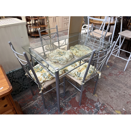 140 - A modern bevelled glass top and metal dining table and four chairs - approx. 76cm high x 75cm wide x... 