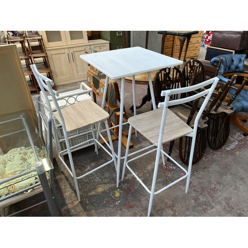 141 - A modern oak effect and white metal bar table and two stools - approx. 111cm high x 60cm wide x 60cm... 