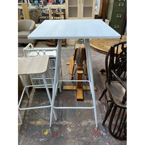 141 - A modern oak effect and white metal bar table and two stools - approx. 111cm high x 60cm wide x 60cm... 