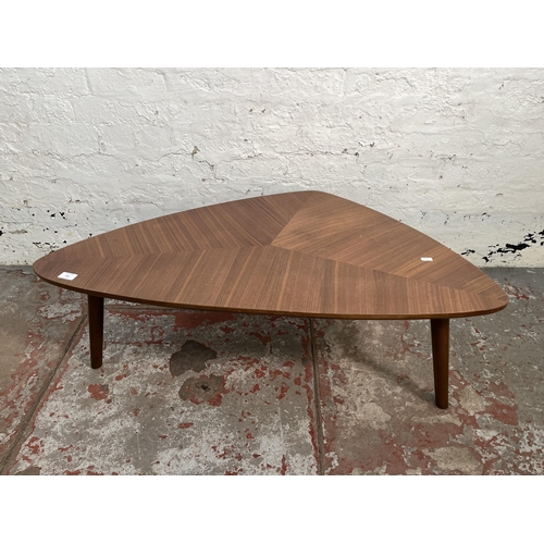 148 - A teak effect triangular coffee table - approx. 36cm high x 58cm wide x 105cm long