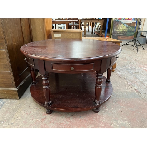 171 - A mahogany circular two tier coffee table - approx. 51cm high x 90cm diameter