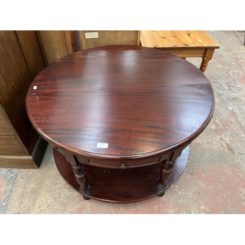 171 - A mahogany circular two tier coffee table - approx. 51cm high x 90cm diameter