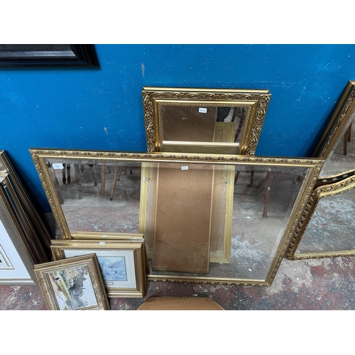 202 - Six gilt framed items, three wall mirrors and three prints - largest approx. 84cm high x 108cm wide