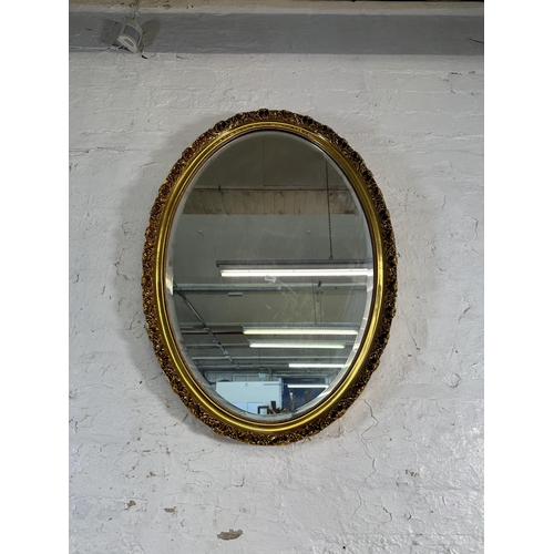 209 - A 19th century style gilt framed oval bevelled edge wall mirror - approx. 84cm high x 58cm wide