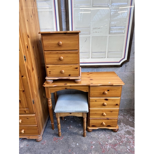 1 - A pine three piece bedroom suite comprising double wardrobe, bedside chest of drawers and dressing t... 