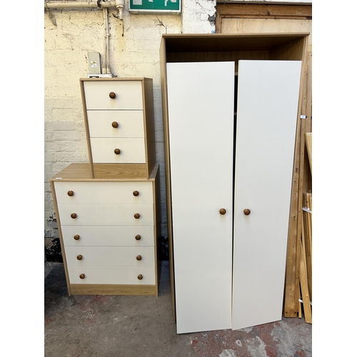 11 - A modern oak effect and white laminate three piece bedroom suite comprising double wardrobe, chest o... 