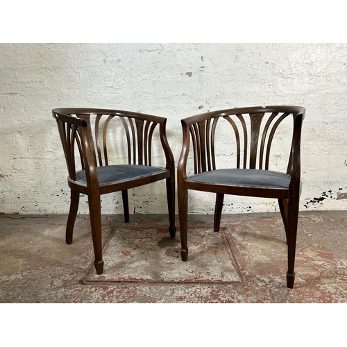 13 - A pair of Edwardian mahogany tub chairs with blue fabric upholstery and tapering supports