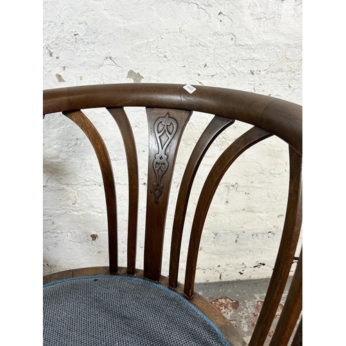 13 - A pair of Edwardian mahogany tub chairs with blue fabric upholstery and tapering supports