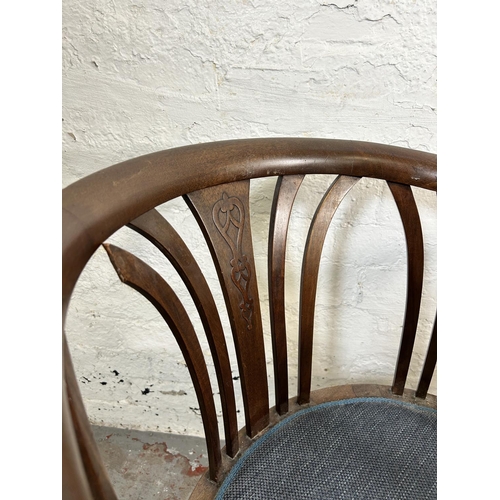 13 - A pair of Edwardian mahogany tub chairs with blue fabric upholstery and tapering supports