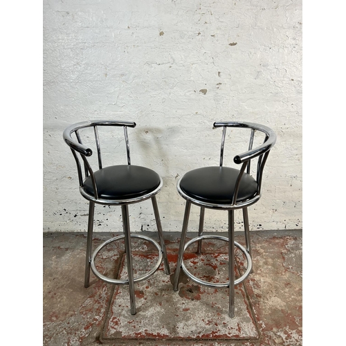 17 - A pair of modern chrome plated and black vinyl swivel bar stools - approx. 90cm high