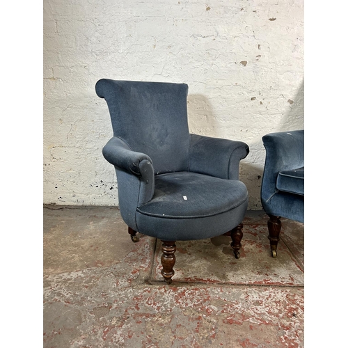 18 - Two Victorian blue fabric upholstered armchairs with turned wooden supports and castors