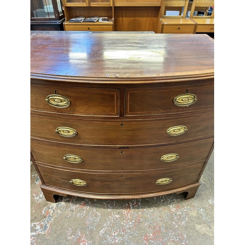 27 - A Georgian mahogany bow fronted chest of drawers on bracket supports with satinwood and ebony crossb... 