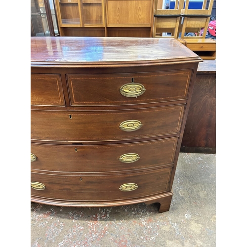 27 - A Georgian mahogany bow fronted chest of drawers on bracket supports with satinwood and ebony crossb... 