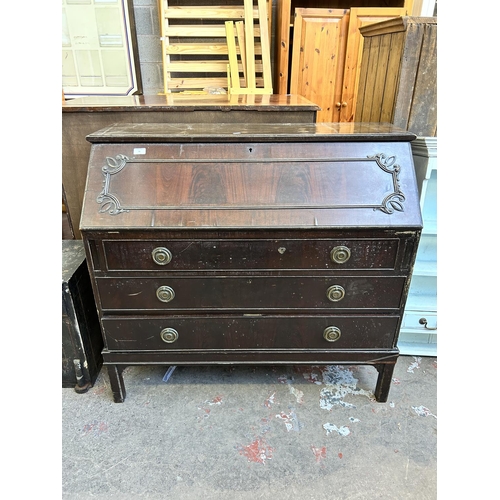 31 - An Edwardian carved mahogany bureau - approx. 100cm high x 110cm wide x 46cm deep