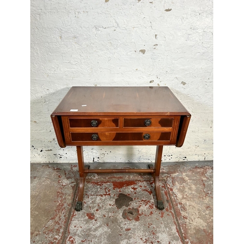 43 - A Regency style yew wood drop leaf three drawer sofa table with brass lion paw feet and lower stretc... 