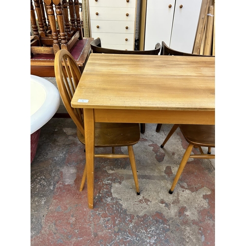 45 - Three pieces of mid 20th century elm and beech furniture, two Ercol Windsor dining chairs and one re... 