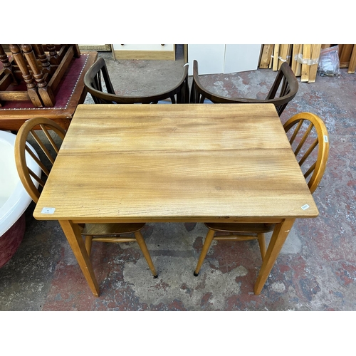 45 - Three pieces of mid 20th century elm and beech furniture, two Ercol Windsor dining chairs and one re... 