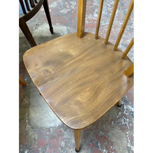 45 - Three pieces of mid 20th century elm and beech furniture, two Ercol Windsor dining chairs and one re... 