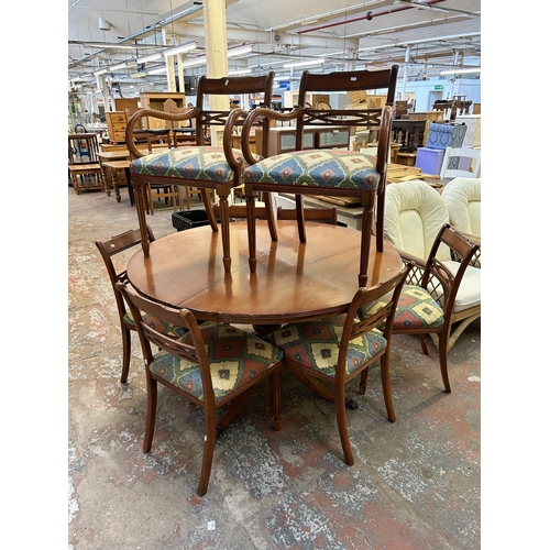 46 - A yew wood circular extending dining table and eight chairs - approx. 79cm high x 137cm diameter