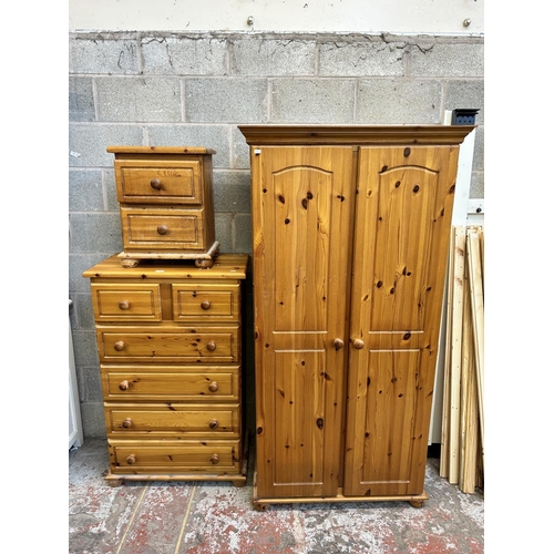 5 - A pine three piece bedroom suite comprising double wardrobe, chest of drawers and bedside chest of d... 