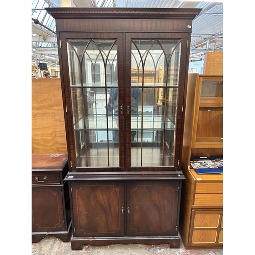 53 - A Georgian style mahogany display cabinet with two glazed doors, four glass shelves and two lower cu... 